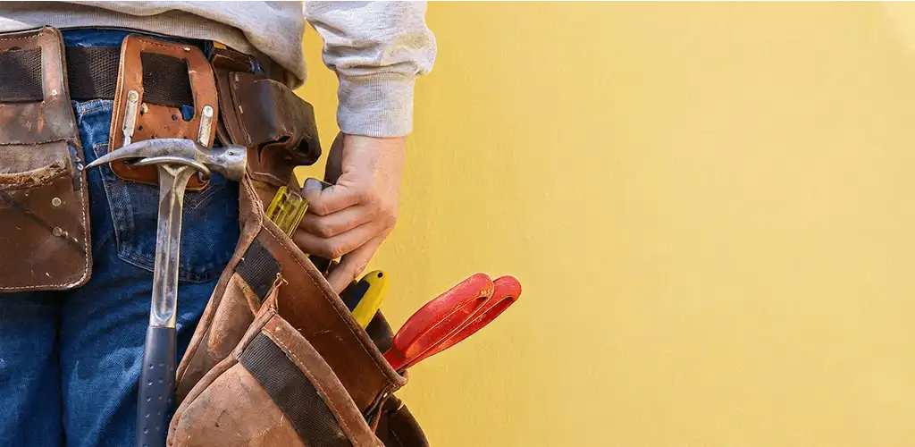 Handyman with tool belt ready for home repairs and maintenance in Sacramento, CA